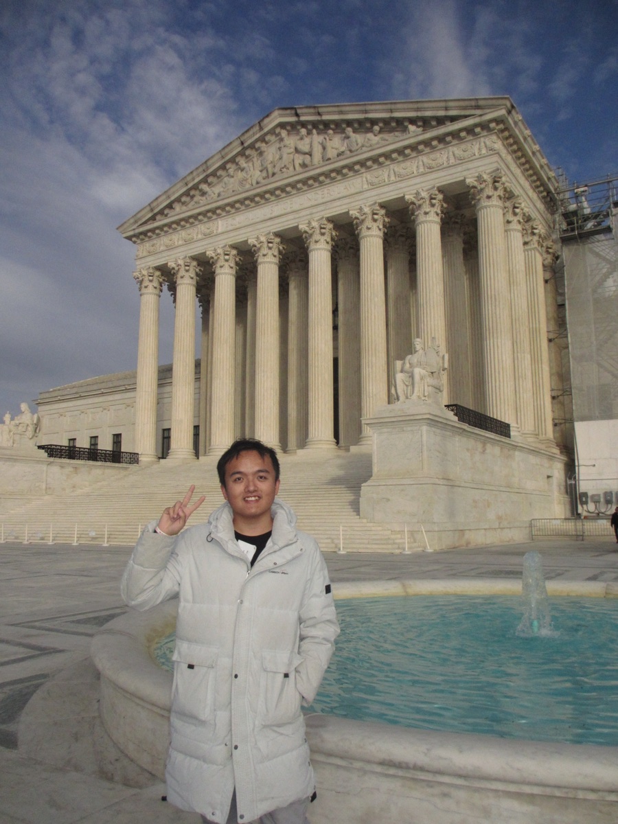 Chun Huang standing in front of the United States Supreme Court